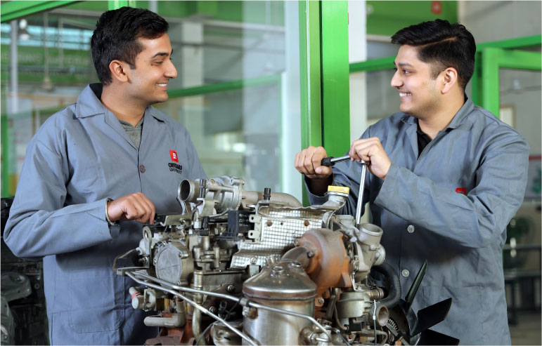 The image shows the two automative engineering students working on their projects.